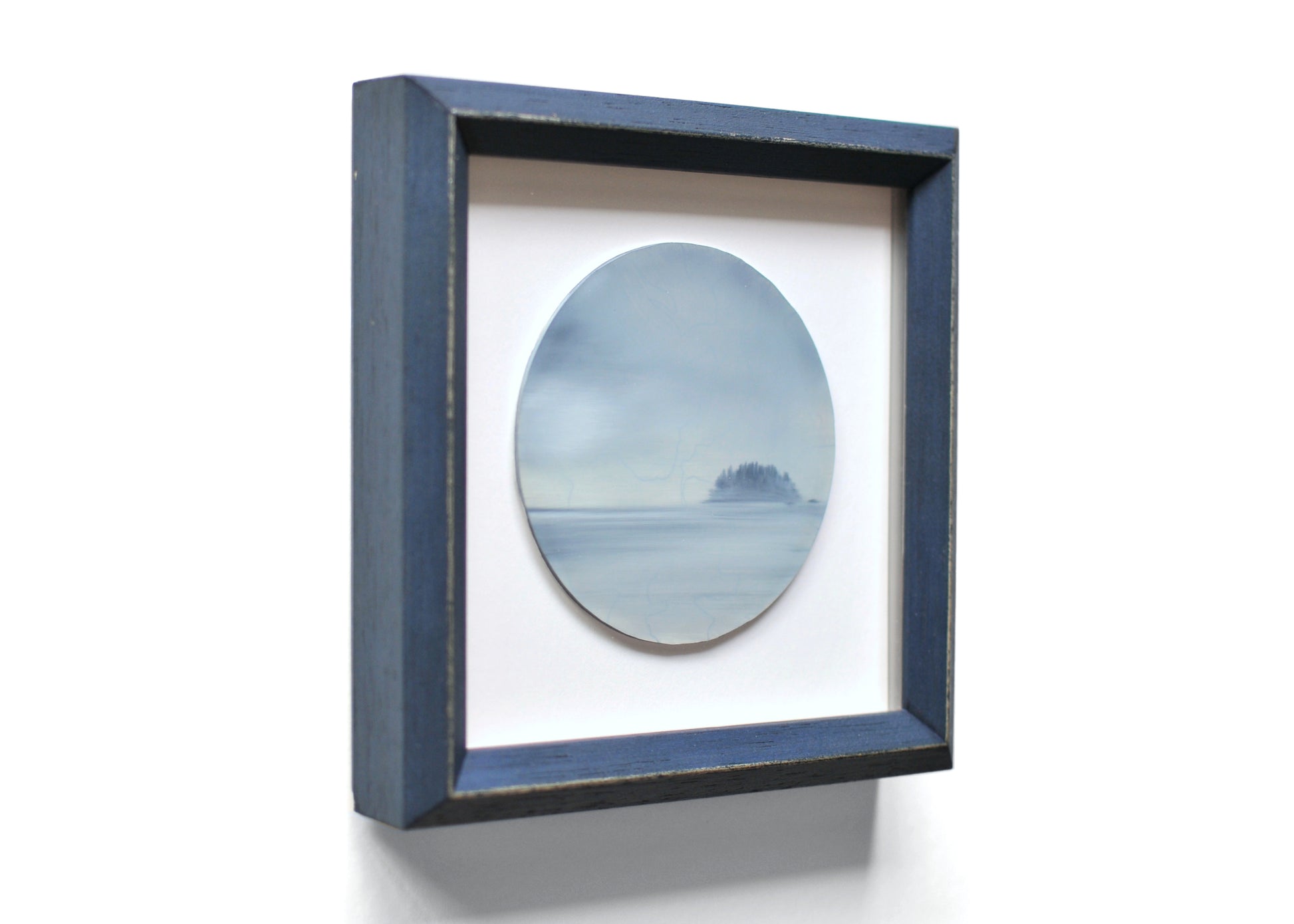 Small, framed oil painting of an island by Natasha van Netten