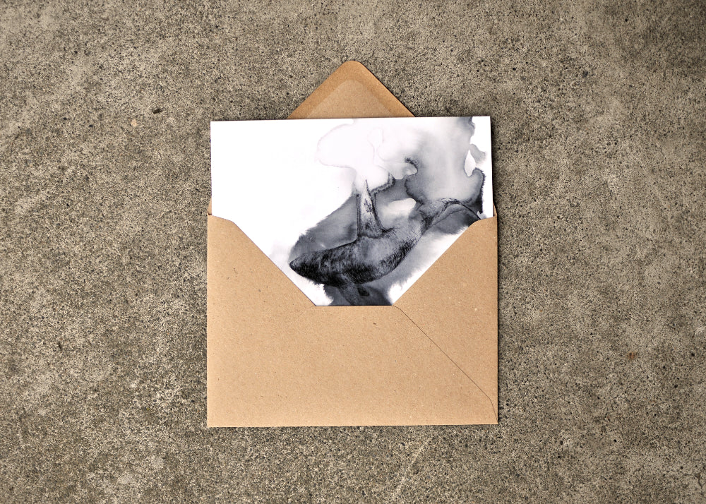 Black Ink Drawing of a Orca on a 5 x 7 greeting card. The card is part way out of the brown envelope.