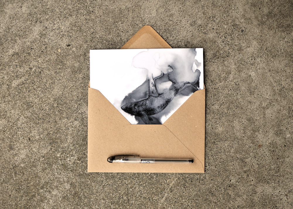 Black Ink Drawing of a Orca on a 5 x 7 greeting card. The card is part way out of the brown envelope. Pen on the envelope showing scale.