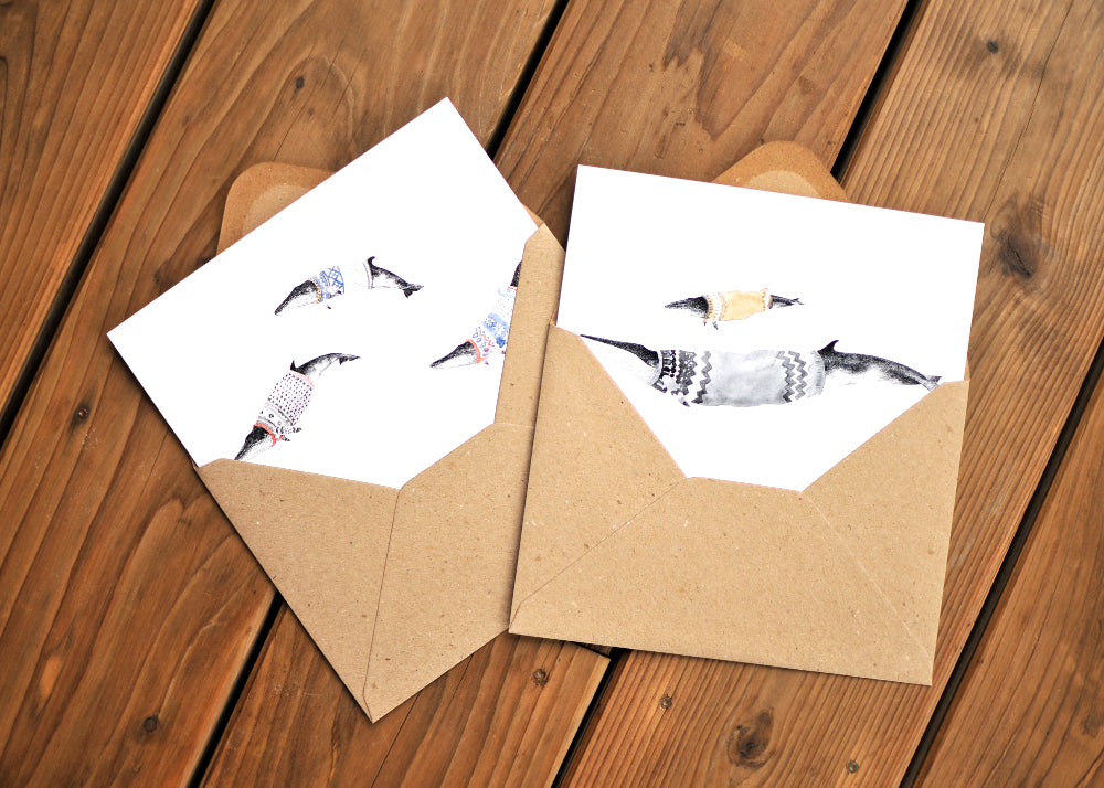 A card with three minke whales wearing Norwegian ski sweaters, called lusekoftes