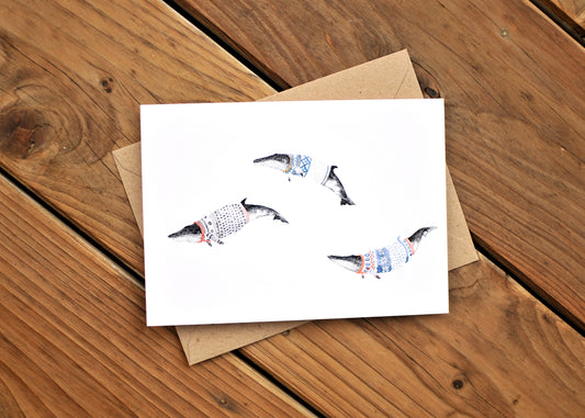 Greeting card with three minke whales wearing Norwegian ski sweaters, called lusekoftes