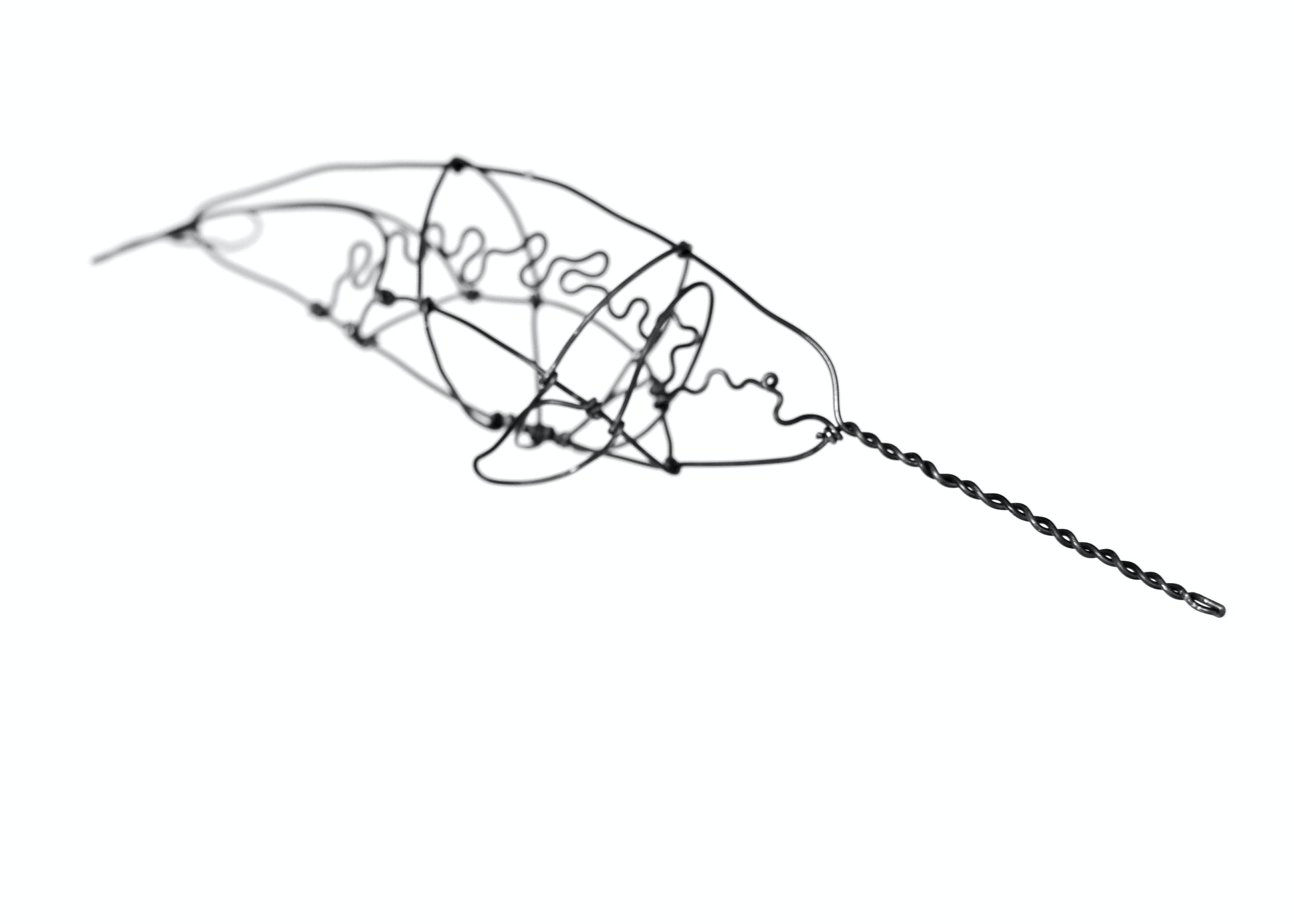 Photo of a 3D wire narwhal whale sculpture.