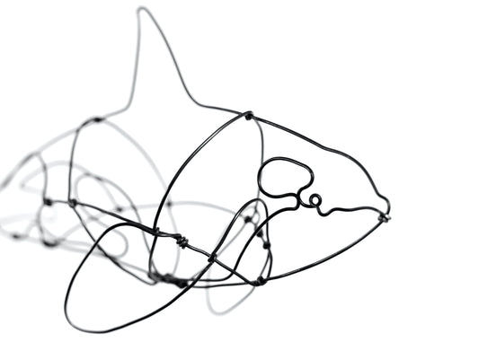 Photo of a 3D wire orca whale sculpture.