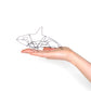 Photo of a 3D wire orca whale sculpture held in a hand.