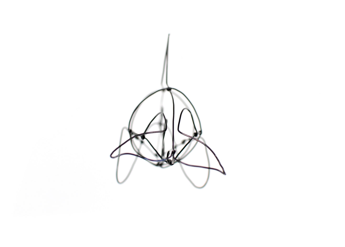 Photo of a 3D wire orca whale sculpture.