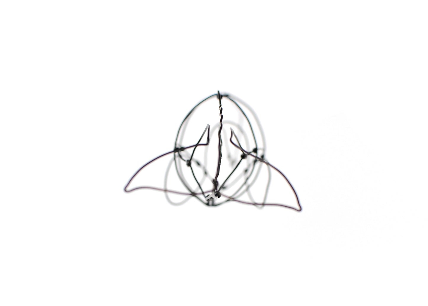 Photo of a 3D wire sperm whale sculpture.