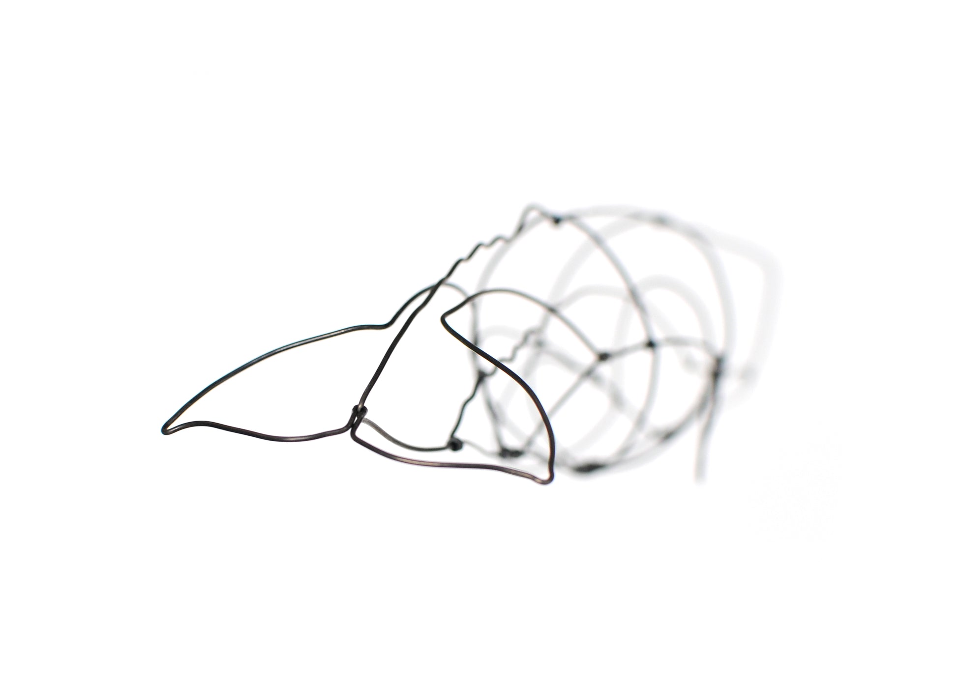 Photo of a 3D wire sperm whale sculpture.