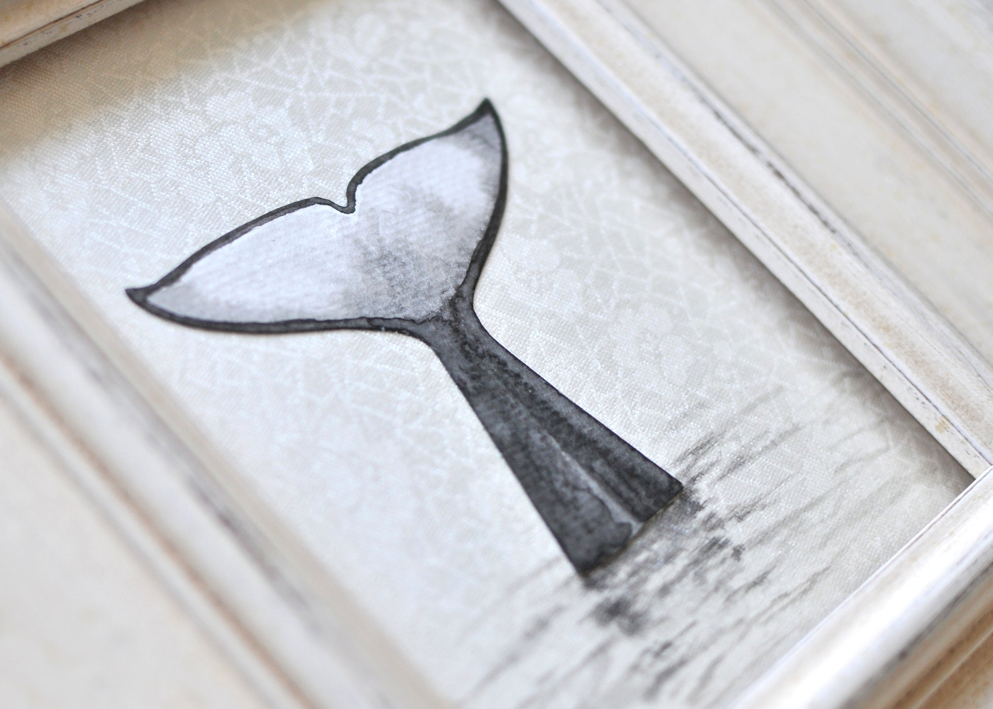 Ink painting of orca's tail mounted to silk 