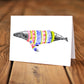 A card with a ink dawing of a humpback whale wearing a colorful sweater.