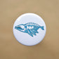 Pin back button with an imaginative skeleton whale.